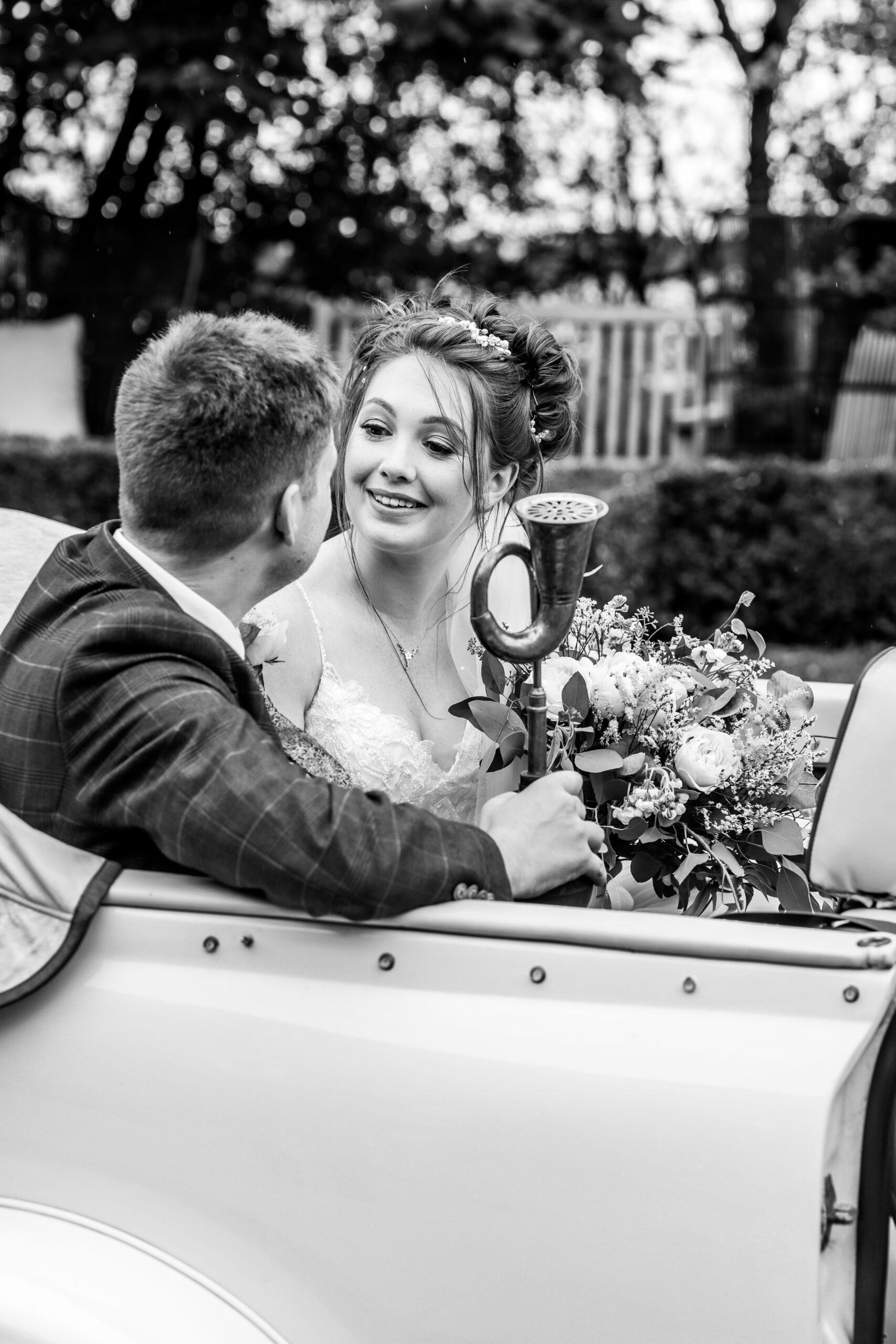A loving look in Bonnie, the wedding car, at The Carriage Hall, Nottinghamshire