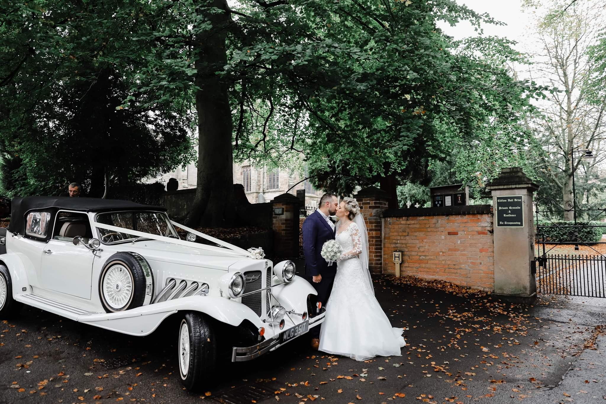 The Bride & Groom ready to drive to their wedding reception at The Nottinghamshire Golf & Country Club in Bonnie, the wedding car