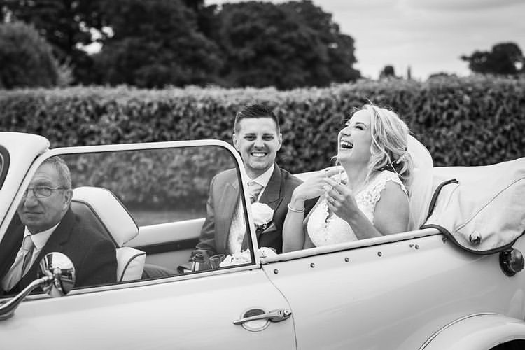 The Bride & Groom sharing a laugh in Bonnie, the wedding car, arriving at The Nottinghamshire Golf & Country Club, Nottinghamshire